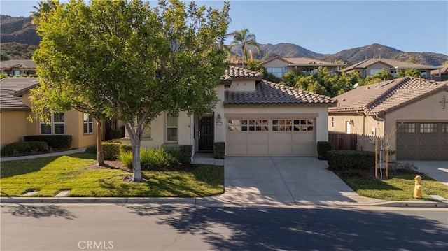 mediterranean / spanish-style house with a front yard and a mountain view