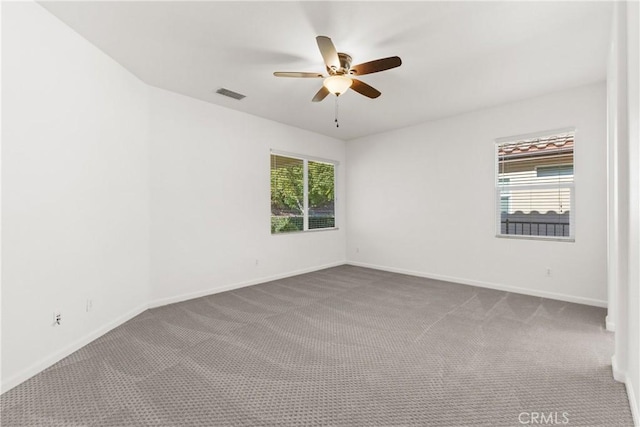 spare room with ceiling fan and carpet flooring