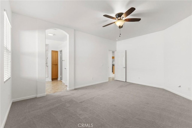 carpeted empty room with ceiling fan