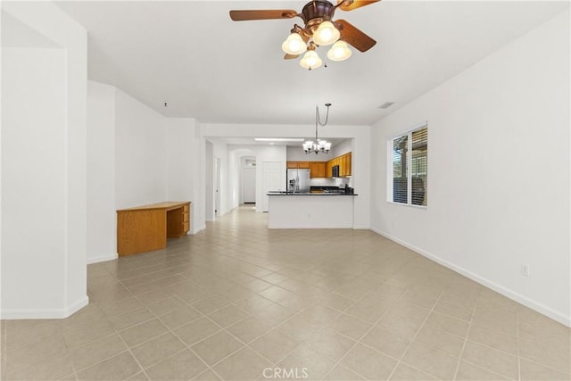 unfurnished living room with ceiling fan with notable chandelier and light tile patterned flooring