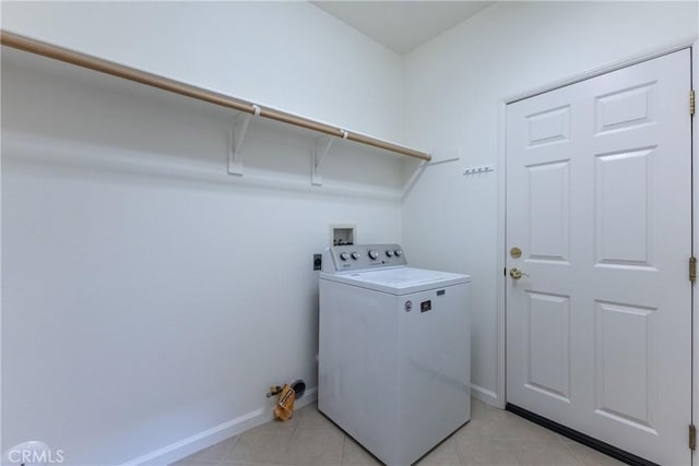 clothes washing area with light tile patterned floors and washer / clothes dryer