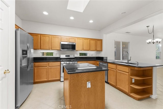 kitchen featuring a kitchen island, kitchen peninsula, sink, appliances with stainless steel finishes, and a chandelier