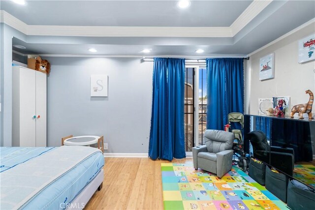 bedroom featuring light hardwood / wood-style flooring and ornamental molding