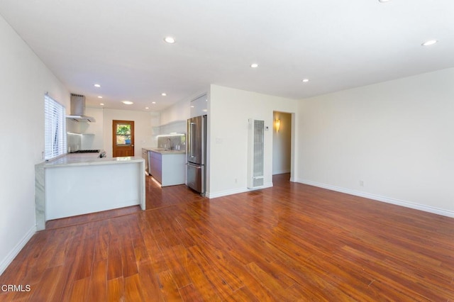 unfurnished living room with dark hardwood / wood-style flooring