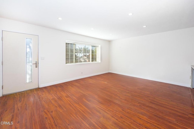 empty room featuring dark hardwood / wood-style flooring