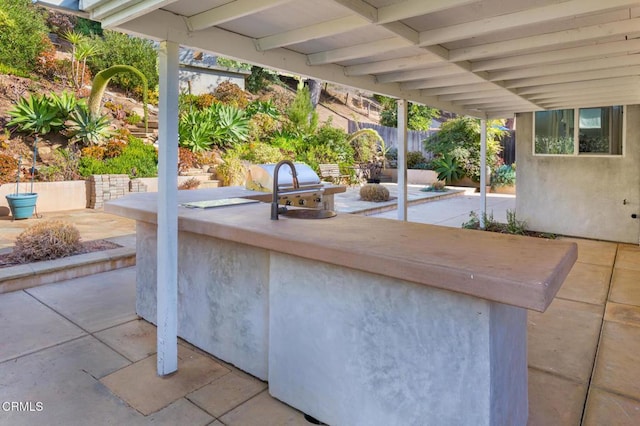 view of patio with area for grilling and sink