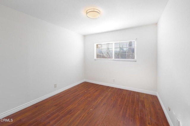 empty room featuring dark wood-type flooring