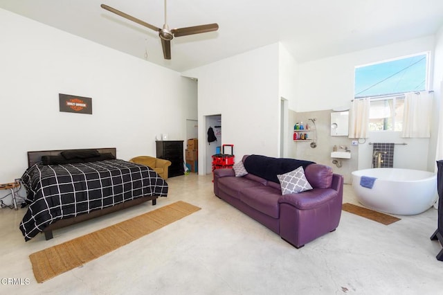 bedroom with ceiling fan and concrete flooring