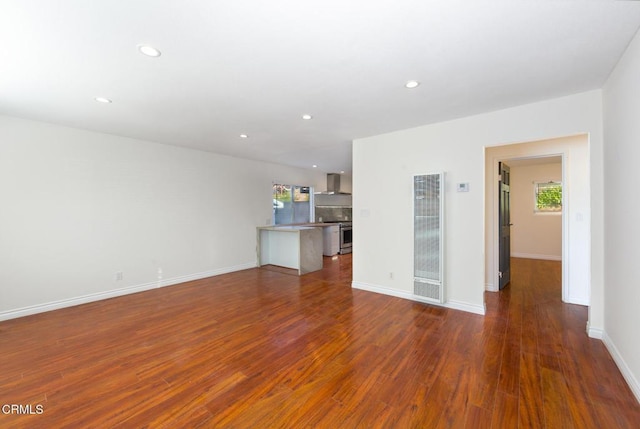 unfurnished living room with plenty of natural light and dark wood-type flooring