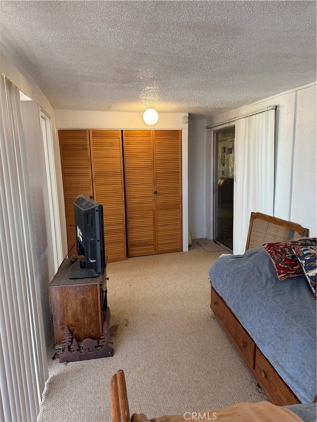 carpeted bedroom with a textured ceiling