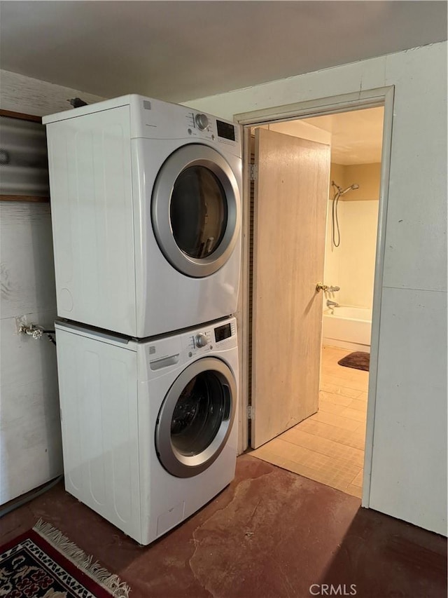 laundry room with stacked washing maching and dryer