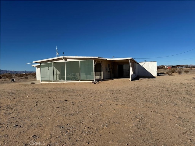 back of house with a sunroom