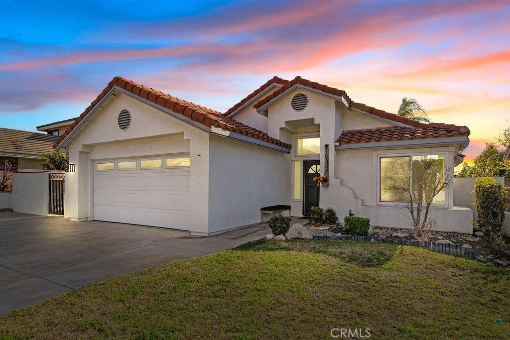 mediterranean / spanish-style home featuring a garage and a lawn