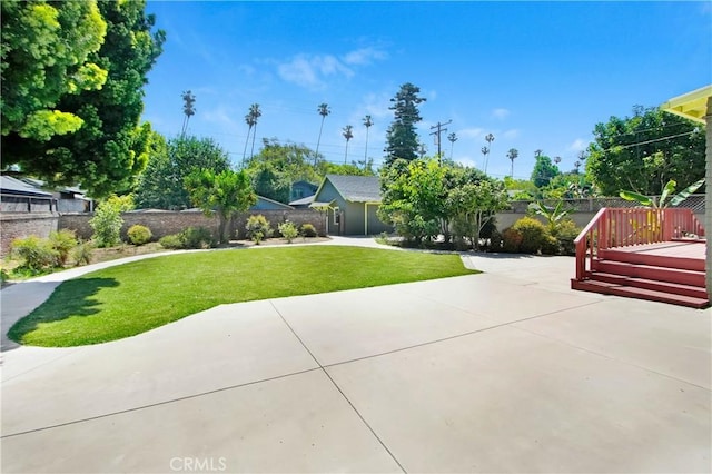 view of home's community with a wooden deck, a yard, and a patio