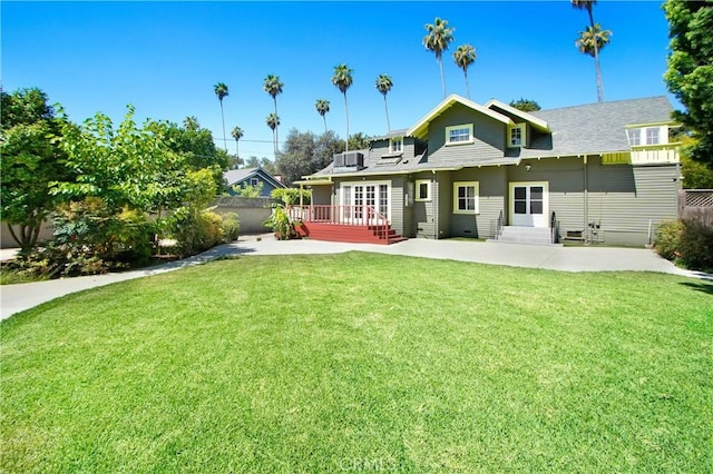 back of property with a yard, central AC, solar panels, and a patio