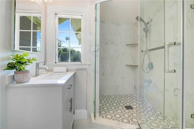 bathroom with walk in shower and vanity