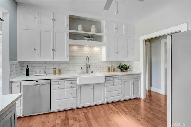 kitchen with decorative backsplash, sink, white cabinets, and stainless steel appliances