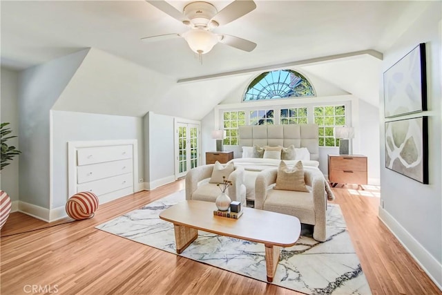 bedroom featuring ceiling fan, hardwood / wood-style flooring, and vaulted ceiling with beams