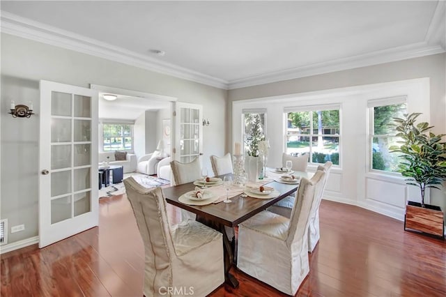 dining area with dark hardwood / wood-style floors, ornamental molding, and french doors