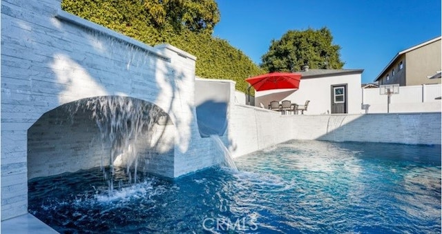 view of pool with pool water feature