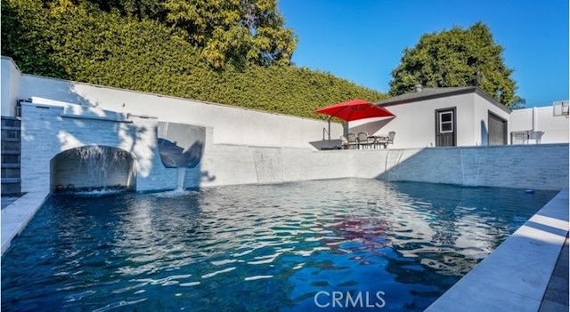 view of pool featuring a patio area and pool water feature