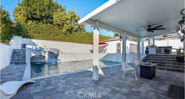 view of patio / terrace with ceiling fan and exterior kitchen