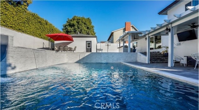 view of pool featuring ceiling fan and a patio area