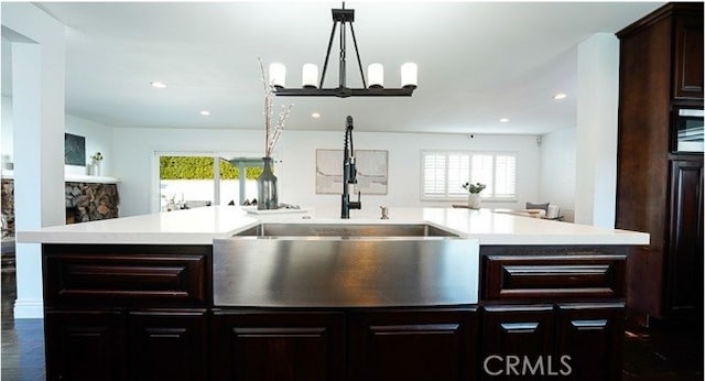 kitchen with an island with sink, sink, and a healthy amount of sunlight