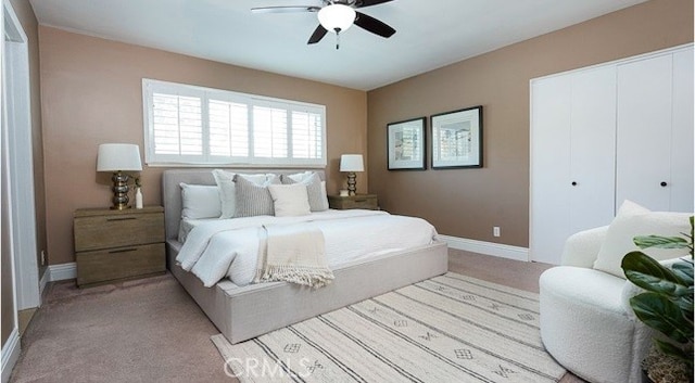 carpeted bedroom with a closet and ceiling fan