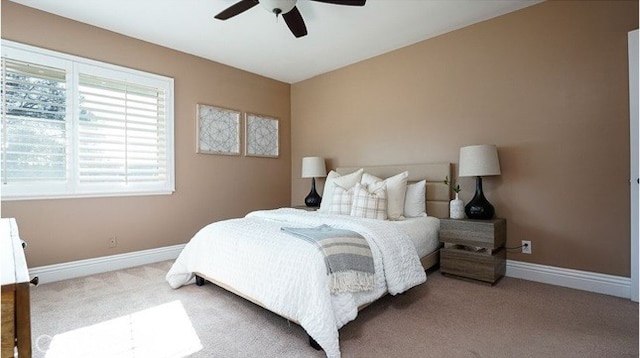 bedroom with ceiling fan and light carpet