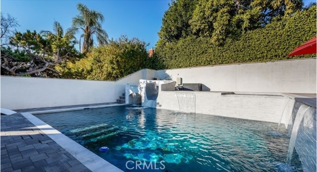 view of pool with pool water feature