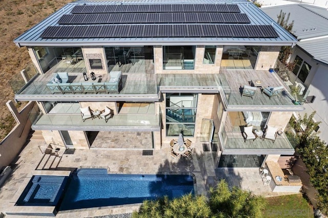 rear view of property with solar panels