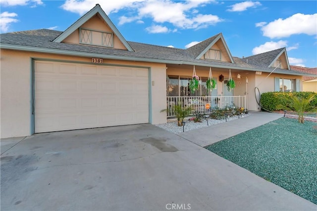 view of front of home with a porch and a garage