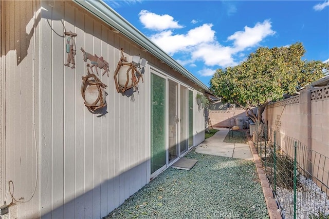 view of side of property with a patio