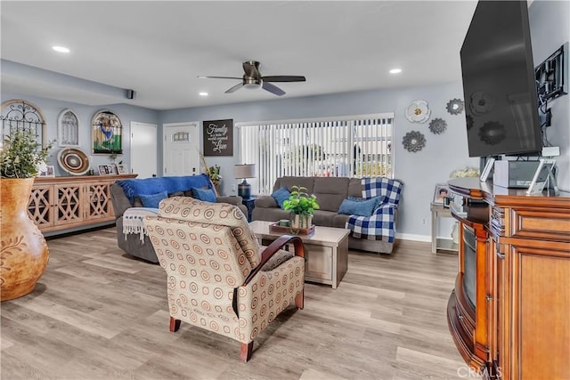 living room featuring ceiling fan and light wood-type flooring