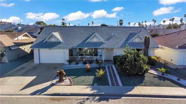 view of front of property with covered porch and a garage