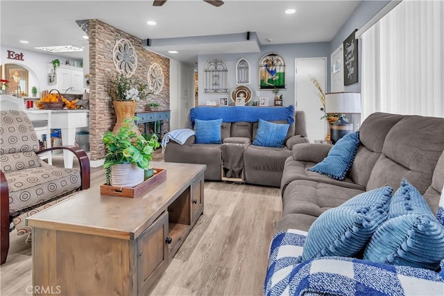 living room featuring ceiling fan and light hardwood / wood-style flooring