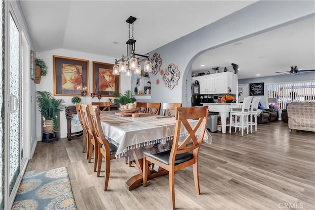 dining room featuring ceiling fan, light hardwood / wood-style flooring, and lofted ceiling