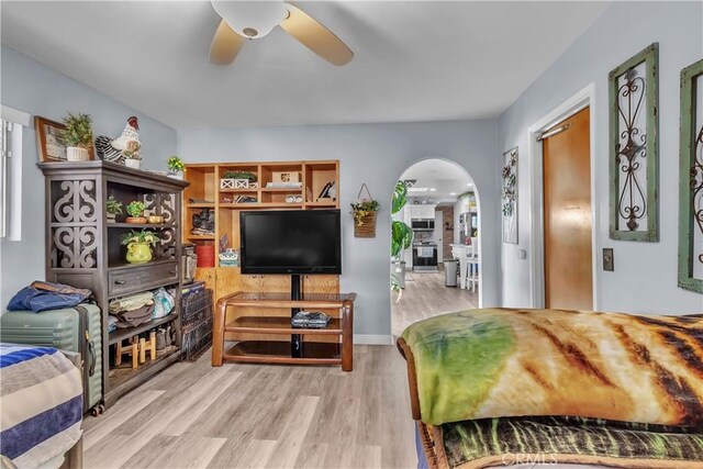 living room with ceiling fan and light hardwood / wood-style flooring