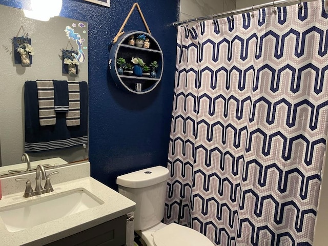 bathroom featuring vanity, toilet, and a shower with shower curtain