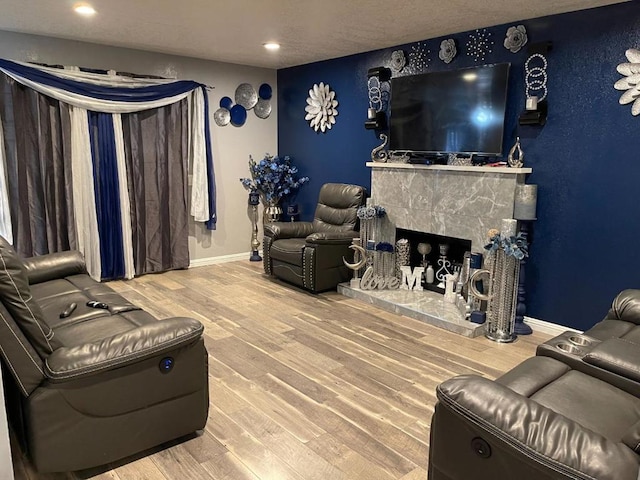 living room with hardwood / wood-style flooring and a tile fireplace