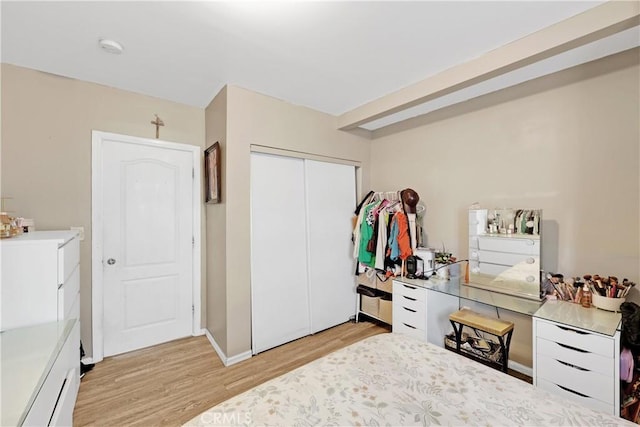 bedroom with a closet and light hardwood / wood-style flooring