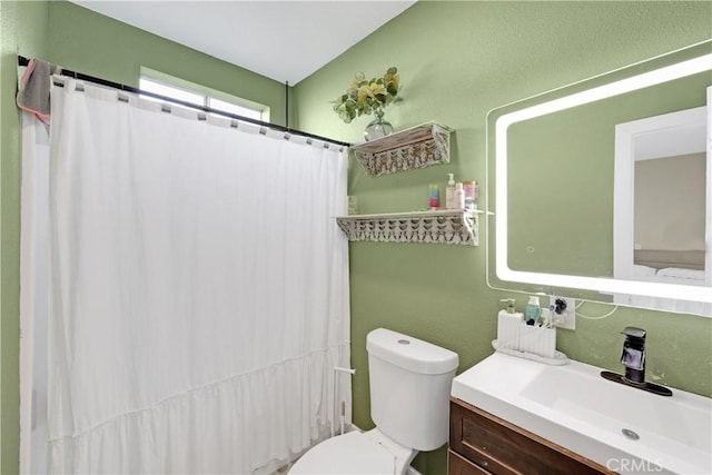 bathroom featuring toilet, a shower with curtain, and vanity