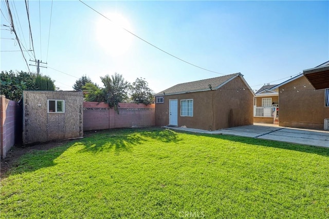 view of yard featuring a patio area and a storage unit