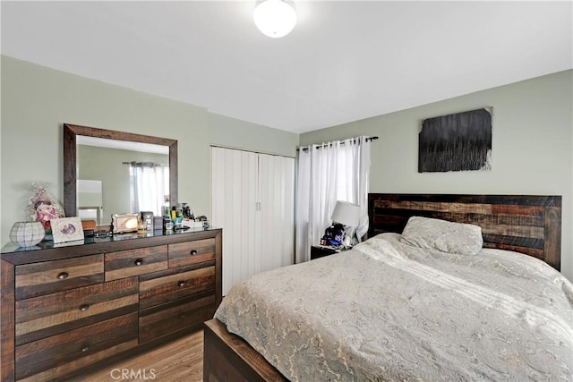 bedroom featuring light hardwood / wood-style flooring and a closet