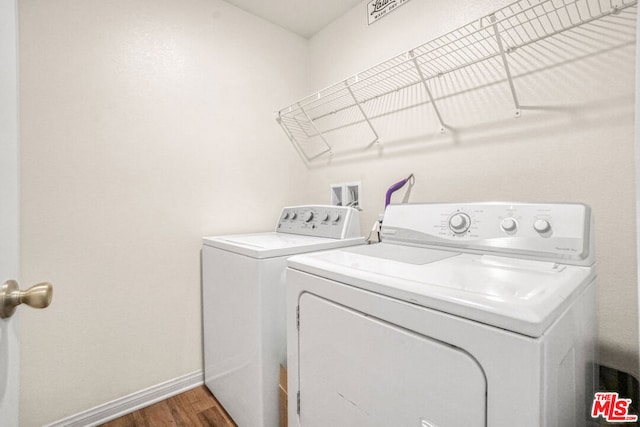 laundry room featuring independent washer and dryer and dark hardwood / wood-style floors