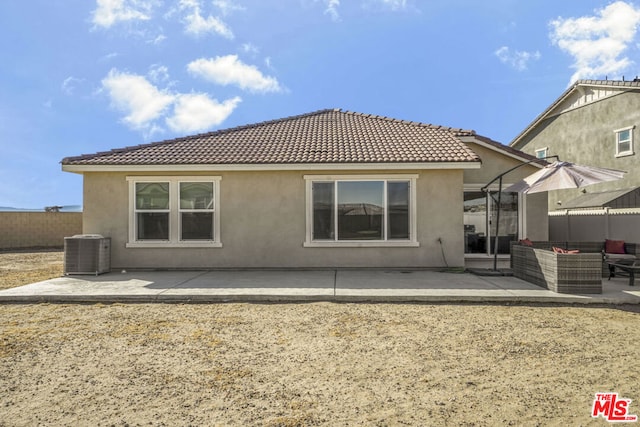 back of house featuring a patio area and central air condition unit