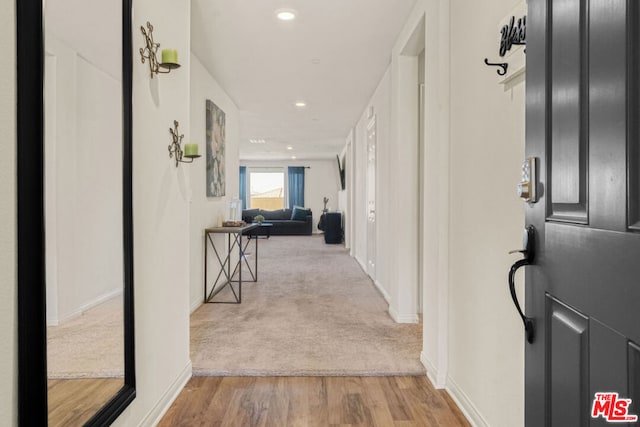 hallway with light hardwood / wood-style floors