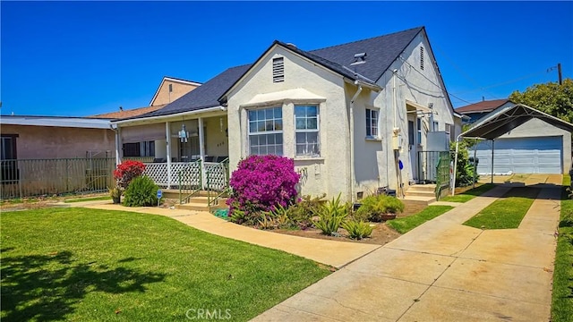 view of front of property with a garage, a front lawn, an outdoor structure, and a porch