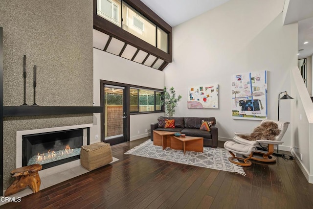 living room featuring wood-type flooring and a high ceiling